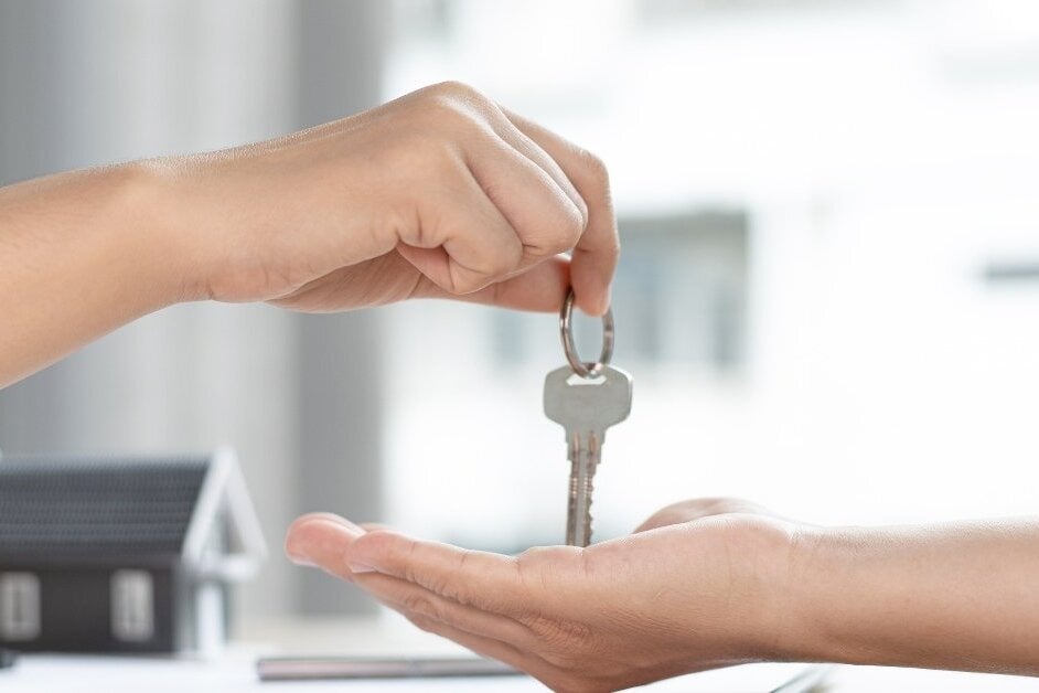 Handing house keys to new costumer