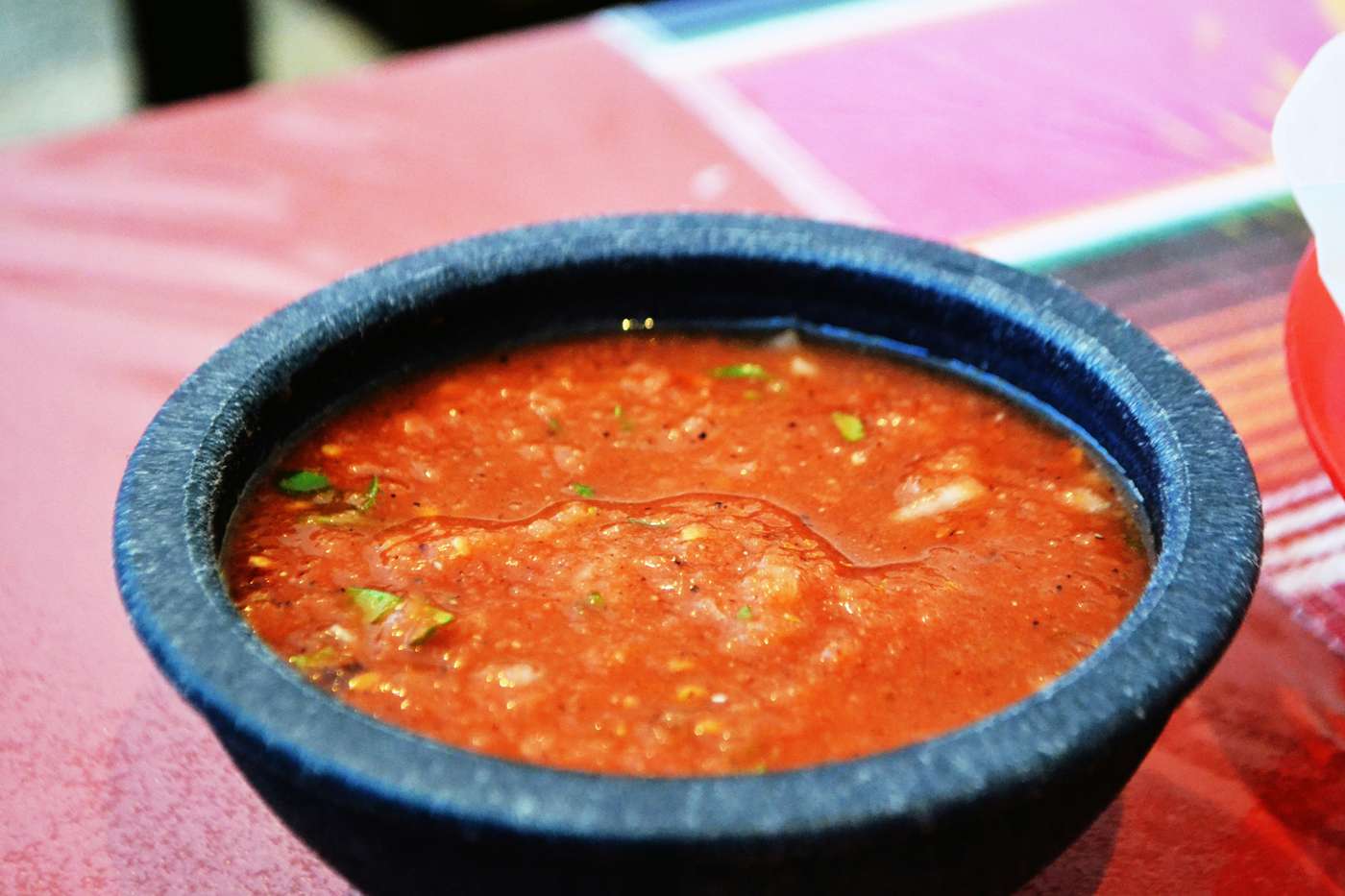 C4PxXHid_84 a bowl of soup sitting on top of a table